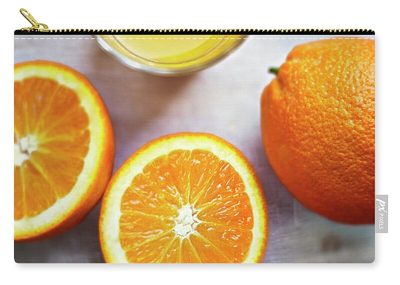 Orange Zip Pouch featuring the photograph Oranges, Halves Of Oranges And A Glass by Westend61