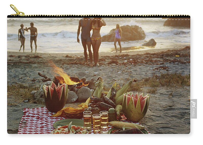Young Men Zip Pouch featuring the photograph Picnic On Beach by Tom Kelley Archive