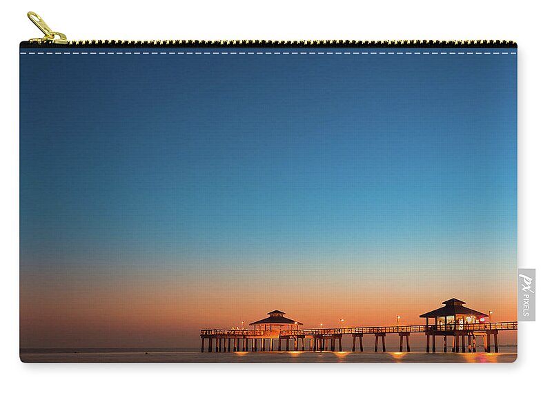Water's Edge Zip Pouch featuring the photograph Pier Boardwalk At Twilight by Moreiso