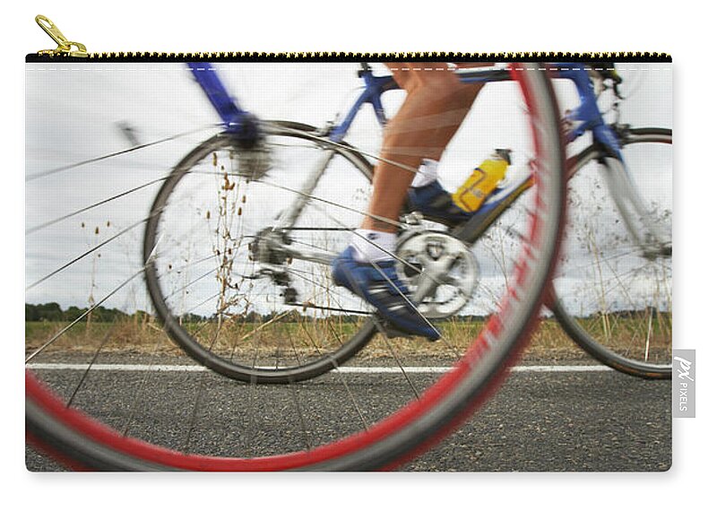 One Man Only Zip Pouch featuring the photograph Road Cyclist, Bicycle Wheel In by Thomas Northcut