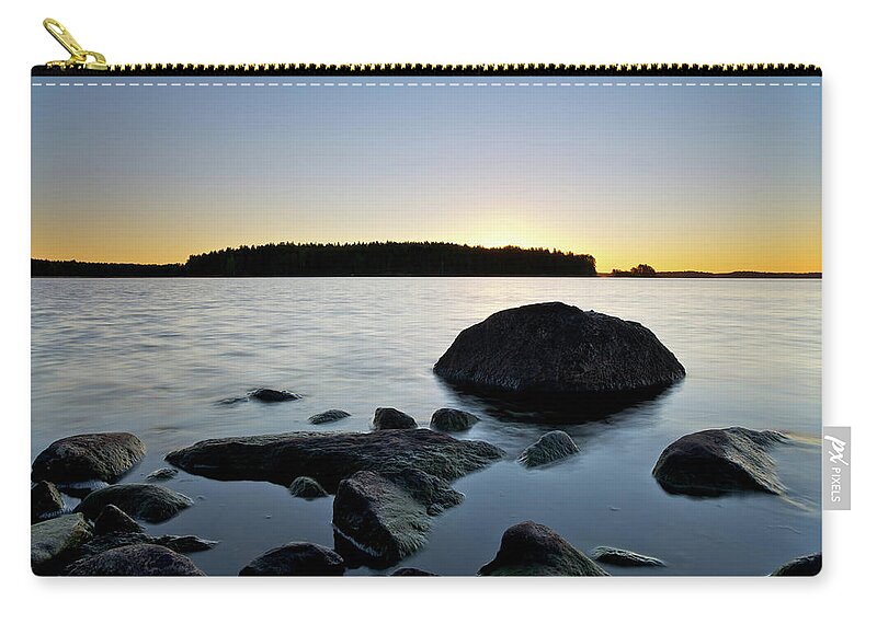 Scenics Zip Pouch featuring the photograph Rocks At Sunrise by Petri Karvonen @ Getty Images