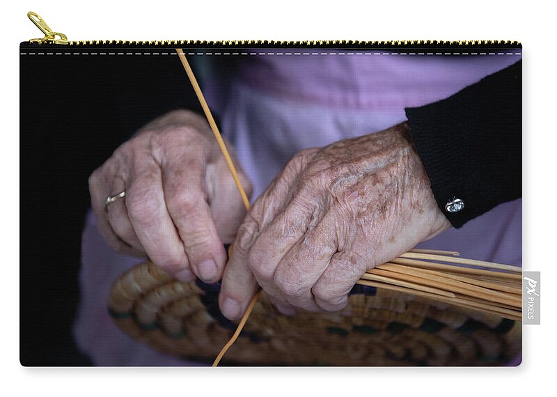 Knitting Zip Pouch featuring the photograph Senior woman knitting a traditional basket with reeds  by Michalakis Ppalis