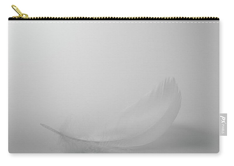 Fragility Zip Pouch featuring the photograph Single White Feather On White Background by Dougal Waters