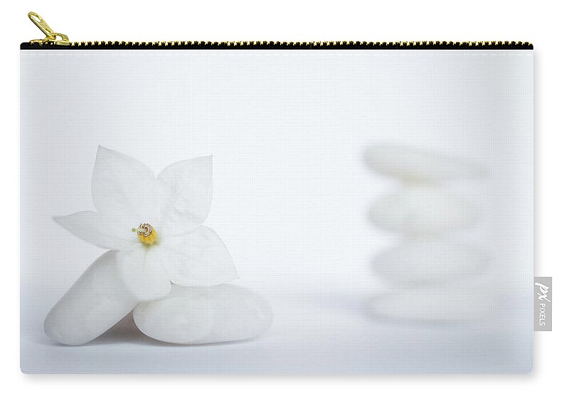 White Background Zip Pouch featuring the photograph Stack Of White Pebbles And Jasmine by G.g.bruno