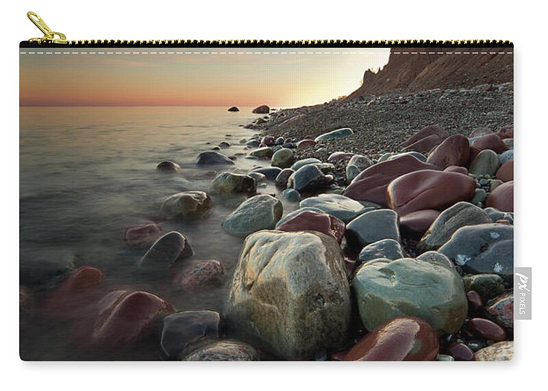 Water's Edge Zip Pouch featuring the photograph Sunrise At Chimney Bluffs by David Copley