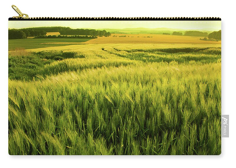 Non-urban Scene Zip Pouch featuring the photograph Sunshine Over A Wheat Field by Nikada