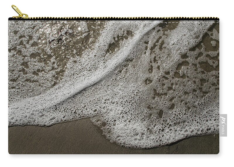 Surf Zip Pouch featuring the photograph Surf Foam On The Sand by Alan Goldberg