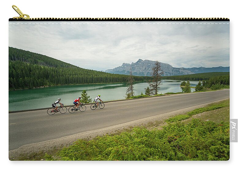 Scenics Zip Pouch featuring the photograph Three Bikers Pedal Down Quiet Mountain by Ascent Xmedia