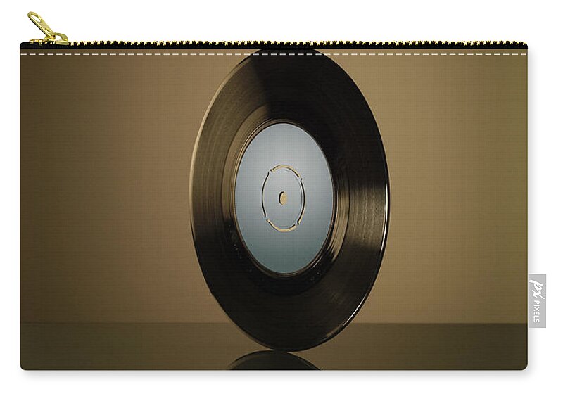 Music Zip Pouch featuring the photograph Vinyl Record On Reflective Surface by Jonathan Knowles