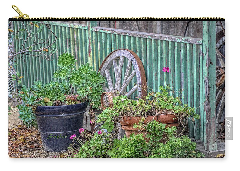 Wagon Wheels And Potted Plants Zip Pouch featuring the photograph Wagon Wheels and Potted Plants by Barbara Snyder