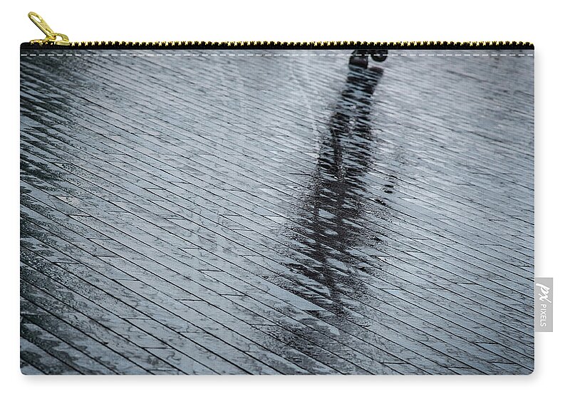 Silhouette Zip Pouch featuring the photograph Walking shadow of an unrecognised person walking on wet streets by Michalakis Ppalis