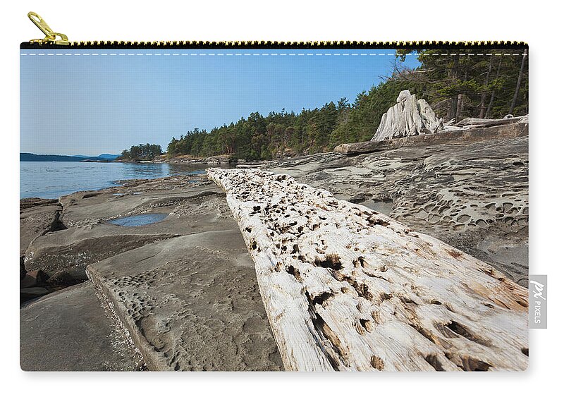Driftwood Zip Pouch featuring the photograph Weathered Driftwood And Rock Formations by Debra Brash / Design Pics