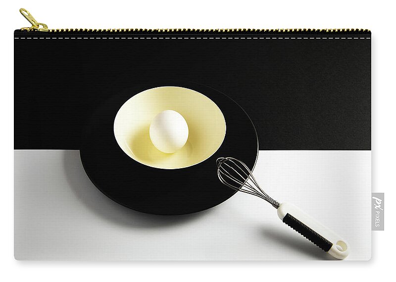 Egg Carry-all Pouch featuring the photograph White egg on a yellow bowl. by Michalakis Ppalis