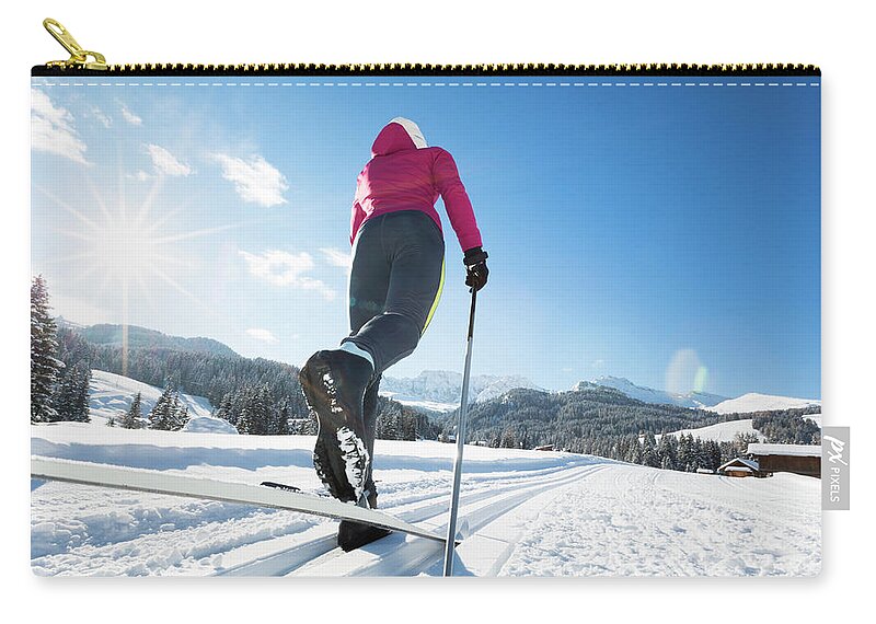 Skiing Zip Pouch featuring the photograph Woman Doing Cross-country Skiing by Tomml