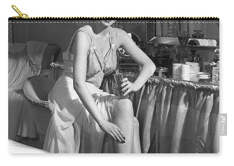 People Zip Pouch featuring the photograph Woman In Bedroom Putting On Lotion by George Marks