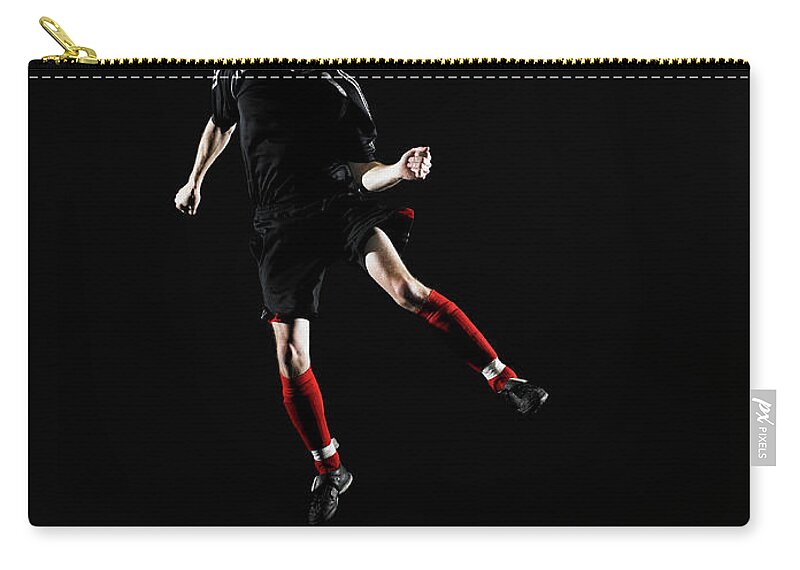 Soccer Uniform Zip Pouch featuring the photograph Young Man Heading Soccer Ball by Thomas Barwick