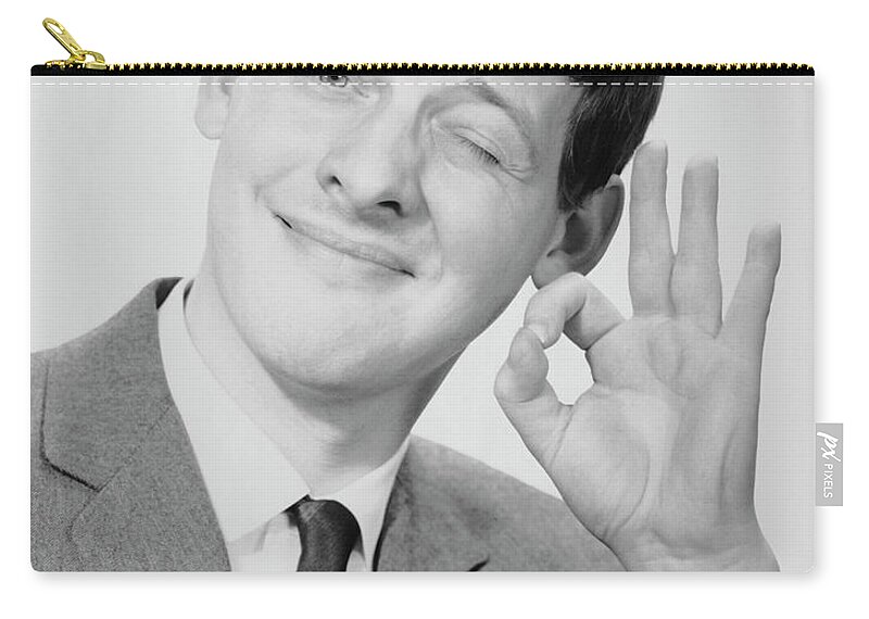 People Zip Pouch featuring the photograph Young Man Making The O.k. Sign by George Marks