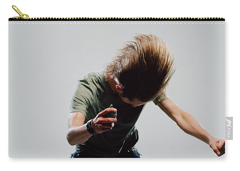 Young Men Zip Pouch featuring the photograph Young Man Striking Pose, Holding Mobile by Erik Von Weber