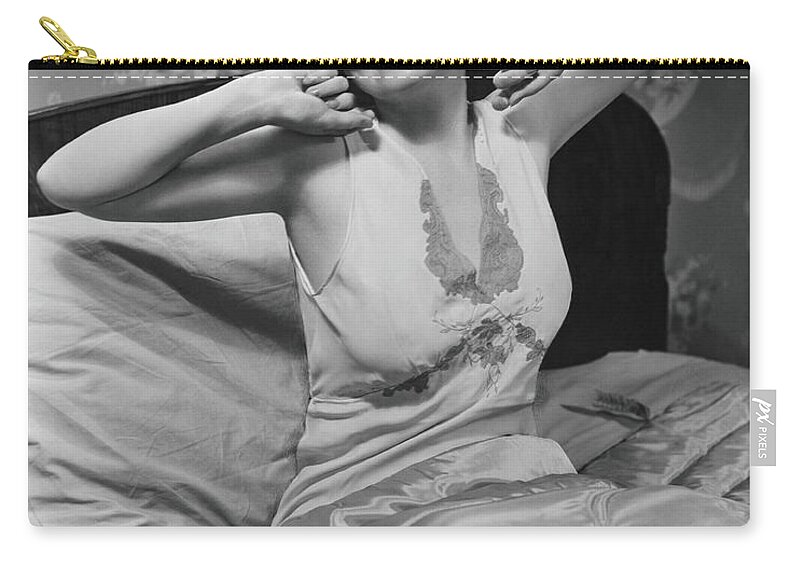 Nightie Zip Pouch featuring the photograph Young Woman Stretching In Bed, B&w by George Marks