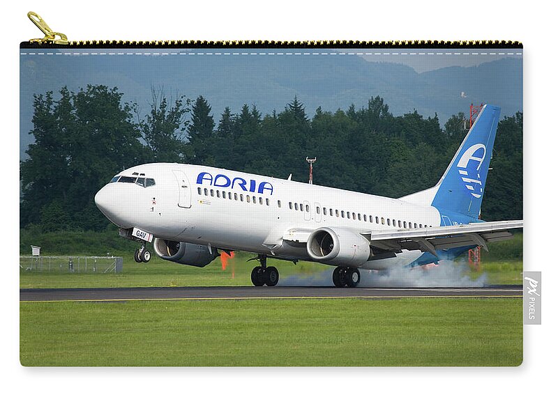 Adria Zip Pouch featuring the photograph Adria aircraft landing at Ljubljana Joze Pucnik Airport #1 by Ian Middleton