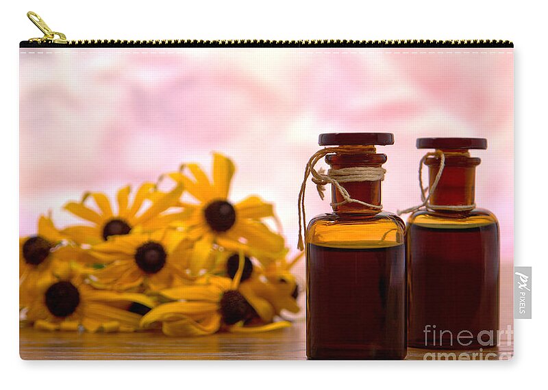 Amber Zip Pouch featuring the photograph Amber Aromatherapy Bottle with Flower Background by Olivier Le Queinec