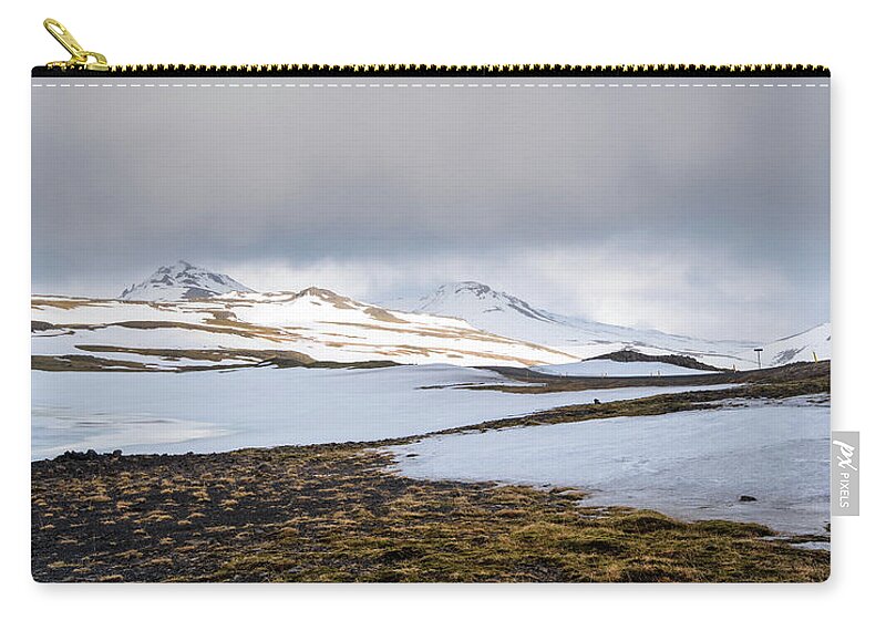 Iceland Zip Pouch featuring the photograph Icelandic landscape with mountains and meadow land covered in snow. Iceland #1 by Michalakis Ppalis