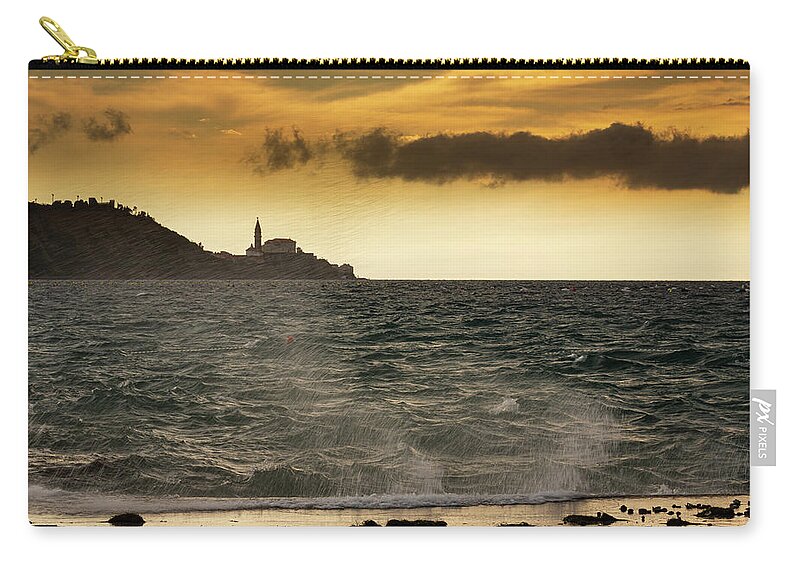 Strunjan Zip Pouch featuring the photograph View of Saint George's Parish Church in Piran #1 by Ian Middleton