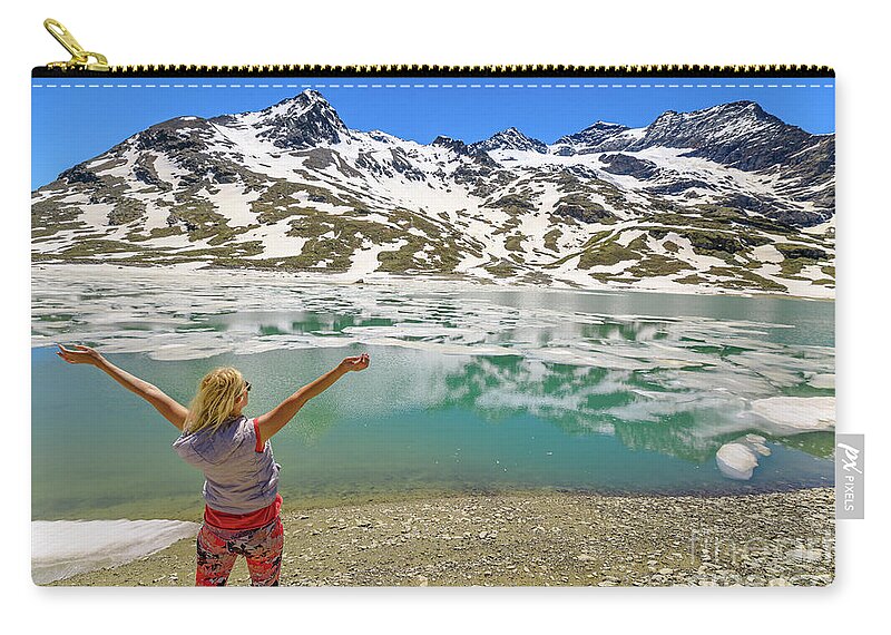 Switzerland Zip Pouch featuring the photograph woman on Swiss White lake trekking #1 by Benny Marty