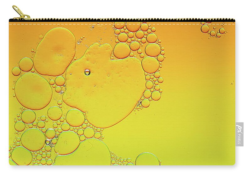 Connection Carry-all Pouch featuring the photograph Bright abstract, yellow background with flying bubbles by Michalakis Ppalis
