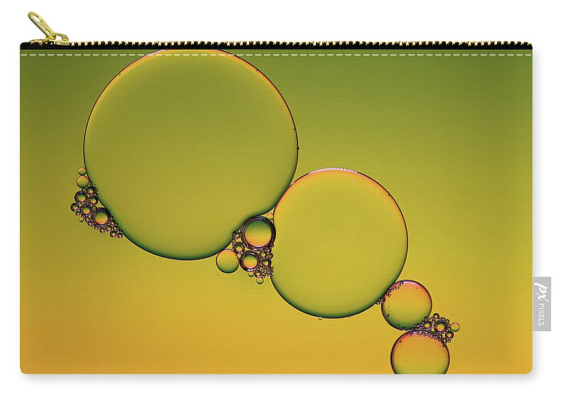 Connection Zip Pouch featuring the photograph Bright abstract, yellow background with flying bubbles #3 by Michalakis Ppalis