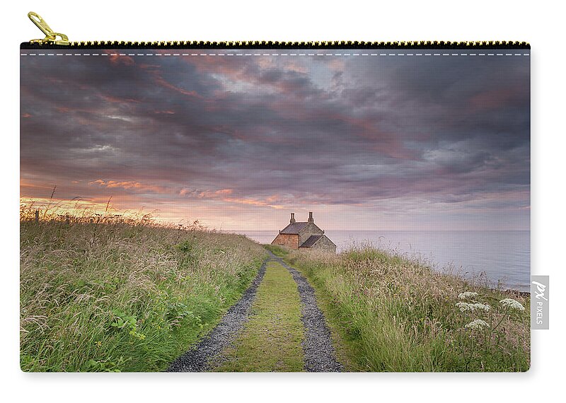 Northumberland Zip Pouch featuring the photograph A cottage by the sea by Anita Nicholson