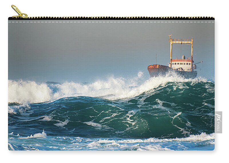 Shipwreck Zip Pouch featuring the photograph Abandoned ship in the stormy ocean by Michalakis Ppalis