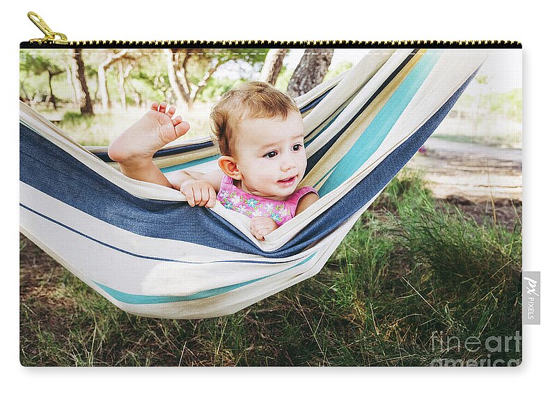 Adorable Zip Pouch featuring the photograph Adorable one year old girl inside a hammock smiling and having f by Joaquin Corbalan
