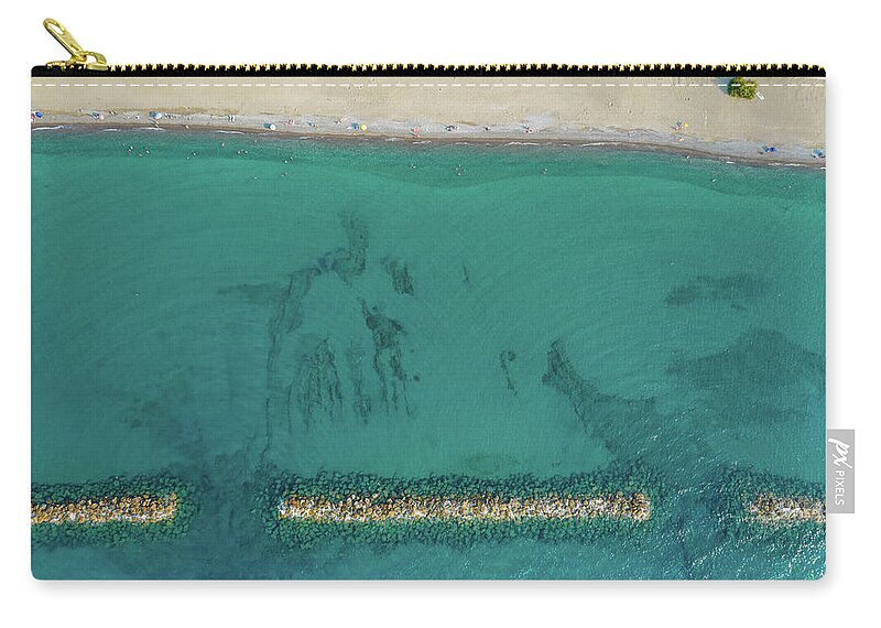 Beachfront Carry-all Pouch featuring the photograph Aerial view from flying drone of people relaxing on the beach. Paphos Cyprus by Michalakis Ppalis