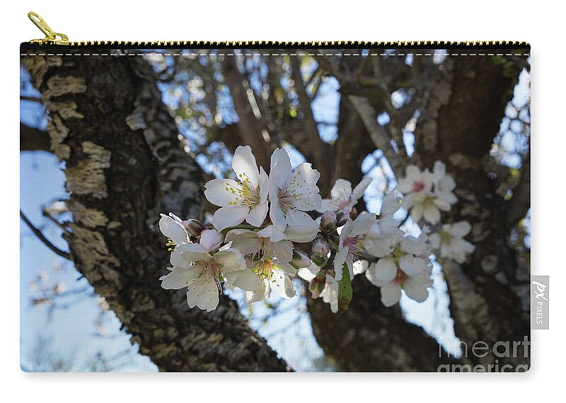 Almond Blossom Carry-all Pouch featuring the photograph White flowers in the penumbra of the almond tree by Adriana Mueller