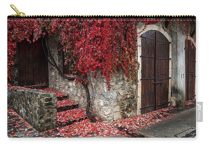 Autumn Zip Pouch featuring the photograph Autumn landscape with red plants on a hous wall by Michalakis Ppalis