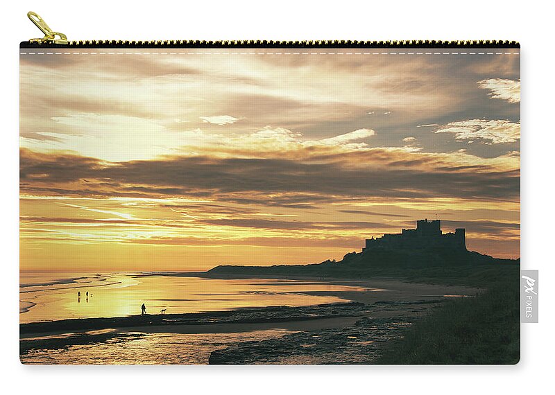 Bamburgh Zip Pouch featuring the photograph Bamburgh castle sunrise by Steev Stamford