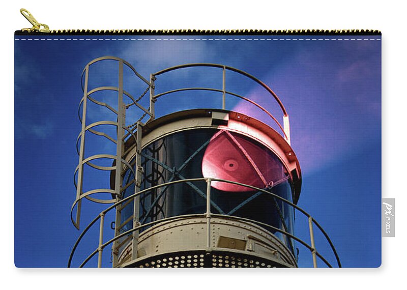 Lighthouse Zip Pouch featuring the photograph Beam of light from a lighthouse. by Bernhard Schaffer