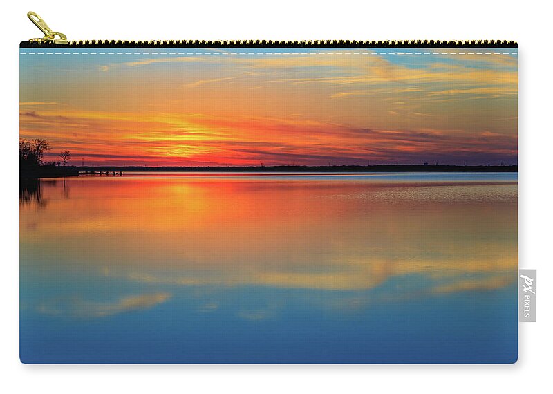 Sunset Zip Pouch featuring the photograph Beautiful lake sunset and its reflection. Very calming. by David Ilzhoefer