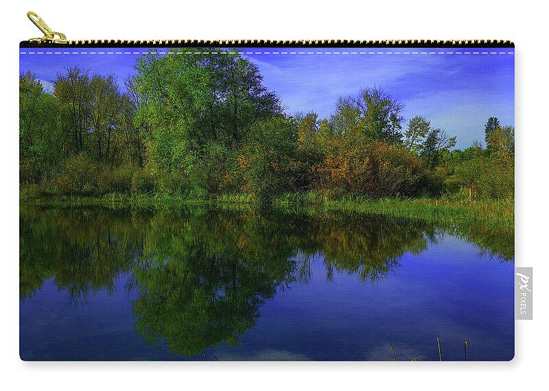 Reflection Zip Pouch featuring the photograph Blue sky and trees reflected in still water by Jeff Swan