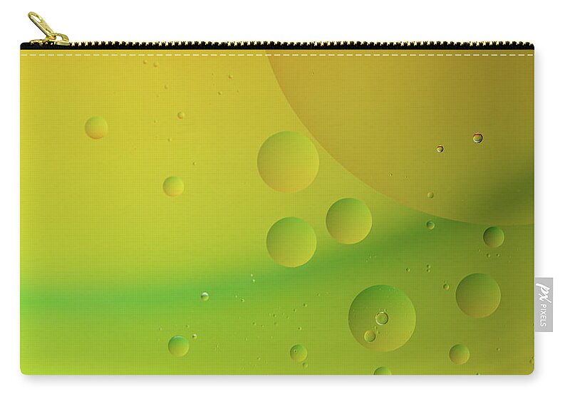 Connection Zip Pouch featuring the photograph Bright abstract green and yellow background with flying bubbles by Michalakis Ppalis