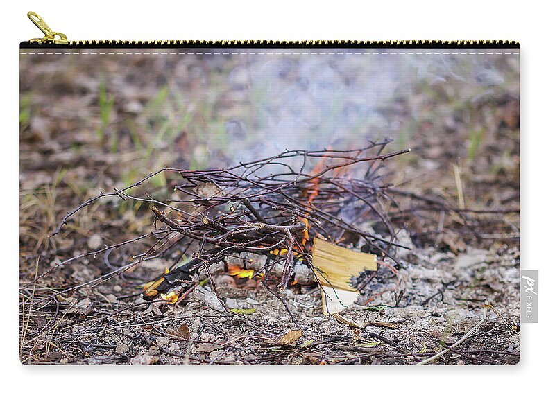 Bonfire Zip Pouch featuring the photograph Burning dry twigs. Bonfire at a camp in summer evening outdoors by Olga Strogonova