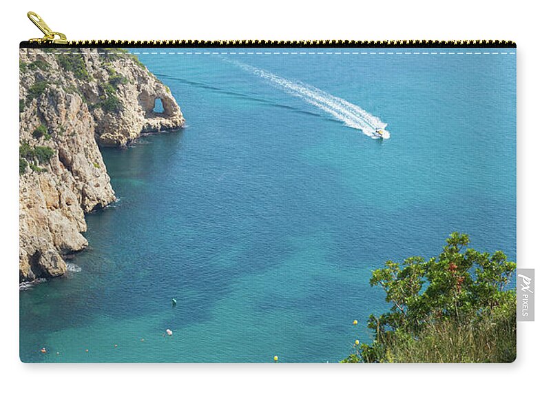 Mediterranean Sea Zip Pouch featuring the photograph Seawater and motor boat. Cala de la Granadella by Adriana Mueller