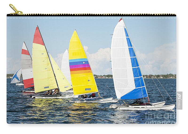 Sky Zip Pouch featuring the photograph Children close sailing, racing catamarans with brightly coloured by Geoff Childs