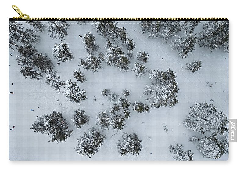 Winter Zip Pouch featuring the photograph Drone aerial scenery of mountain snowy forest and people playing in snow. Wintertime season by Michalakis Ppalis