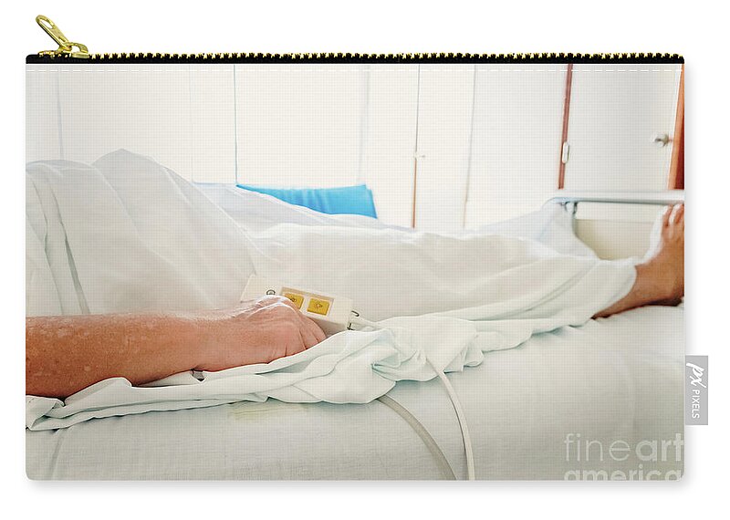 Aged Zip Pouch featuring the photograph Elderly woman convalescing a bedridden disease. by Joaquin Corbalan