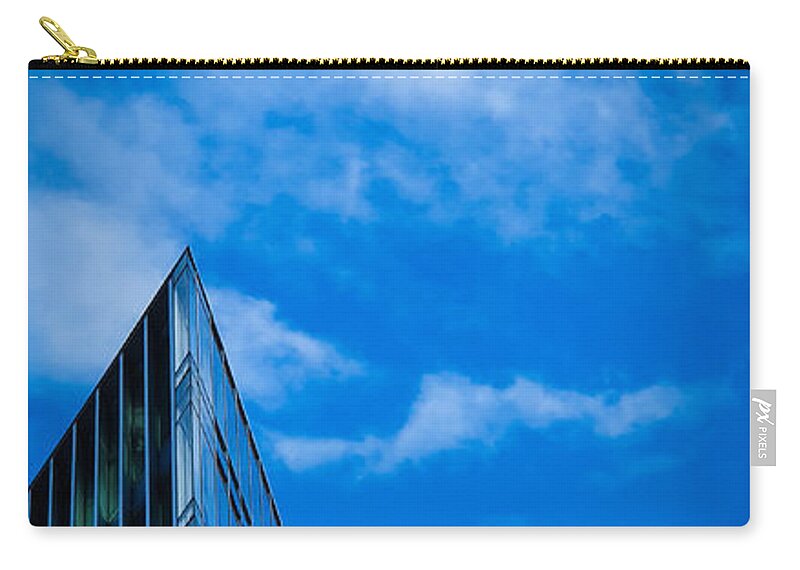 Building Zip Pouch featuring the photograph Futuristic triangular building against a clear blue sky by Mendelex Photography