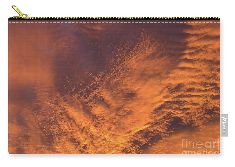 Clouds Zip Pouch featuring the photograph Glowing sunset sky with deep orange clouds by Adriana Mueller
