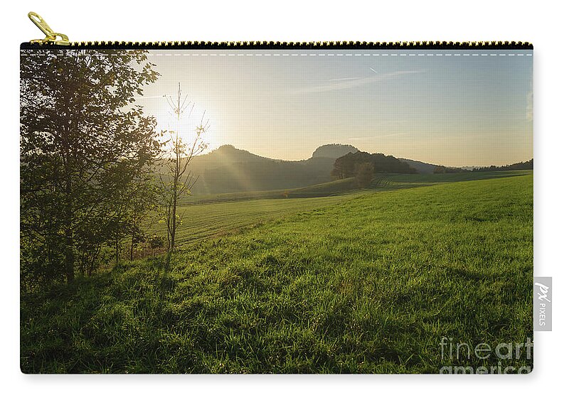 Saxon Switzerland Zip Pouch featuring the photograph Green meadow and golden light 3 by Adriana Mueller