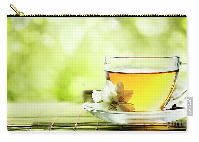Tea Zip Pouch featuring the photograph Herbal cup of tea on wooden table by Jelena Jovanovic